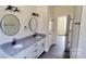 Bathroom features a double vanity with granite countertop and modern fixtures at 330 Fiber Acres A St, Cleveland, NC 27013