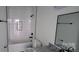 Clean white tiled bathroom with shower-tub combo and granite countertop at 330 Fiber Acres A St, Cleveland, NC 27013
