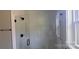 A modern bathroom featuring unique tile in the shower with glass doors and black hardware at 330 Fiber Acres A St, Cleveland, NC 27013