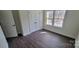 A bedroom featuring stylish flooring, a window view, and a double-door closet at 330 Fiber Acres A St, Cleveland, NC 27013