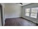 Bright bedroom with wood floors, ceiling fan, and windows with wooded views at 330 Fiber Acres A St, Cleveland, NC 27013