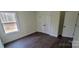 A bedroom featuring stylish flooring, a window view, and a double-door closet at 330 Fiber Acres A St, Cleveland, NC 27013