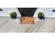 A home's front door with a 'Welcome' mat, potted plants, and a cheerful, inviting appeal at 330 Fiber Acres A St, Cleveland, NC 27013