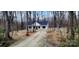 A charming exterior view of a modern home nestled among the trees with a gravel driveway at 330 Fiber Acres A St, Cleveland, NC 27013