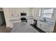 A modern kitchen with white cabinets, granite countertops, stainless steel appliances, and a kitchen island at 330 Fiber Acres A St, Cleveland, NC 27013
