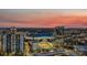 An aerial view of a cityscape with a stadium under a vibrant sunset sky at 333 W Trade St # 2704, Charlotte, NC 28202