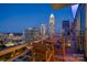 Relax on this balcony with a cozy table and chairs with stunning views of the downtown skyline at 333 W Trade St # 2704, Charlotte, NC 28202