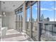 Light-filled bathroom with shower and soaking tub with city views from the large windows at 333 W Trade St # 2704, Charlotte, NC 28202