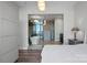 Luxurious main bedroom featuring glass wall into ensuite bathroom with soaker tub at 333 W Trade St # 2704, Charlotte, NC 28202