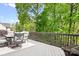 Inviting back deck offers outdoor seating and scenic views surrounded by mature trees at 3934 Blue Dory Ln, Denver, NC 28037