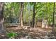 Secluded backyard features a fire pit, trampoline, storage shed, and ample space to play at 3934 Blue Dory Ln, Denver, NC 28037