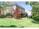 Charming backyard featuring a well-maintained lawn, a spacious deck, and lovely landscaping at 3934 Blue Dory Ln, Denver, NC 28037