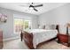 Cozy bedroom with a ceiling fan, natural light, and warm cherry wood furniture at 3934 Blue Dory Ln, Denver, NC 28037