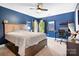 Comfortable blue bedroom with a ceiling fan, a plush bed, and a dedicated workstation at 3934 Blue Dory Ln, Denver, NC 28037