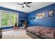 Blue bedroom features a ceiling fan, work station, and a large window at 3934 Blue Dory Ln, Denver, NC 28037