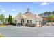 Community clubhouse featuring covered entrances, a gated pool area, and ample parking at 3934 Blue Dory Ln, Denver, NC 28037