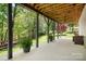 Spacious covered patio with exposed wood ceiling and lush, green surroundings at 3934 Blue Dory Ln, Denver, NC 28037