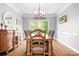 Bright dining room with hardwood floors, a wooden table, and a chandelier at 3934 Blue Dory Ln, Denver, NC 28037