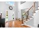 Bright foyer with hardwood floors, staircase, and large windows at 3934 Blue Dory Ln, Denver, NC 28037