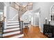 Grand foyer with hardwood floors, elegant staircase, and abundant natural light at 3934 Blue Dory Ln, Denver, NC 28037