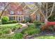 Charming brick home with a beautifully landscaped front yard and a welcoming front porch at 3934 Blue Dory Ln, Denver, NC 28037