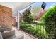 Inviting covered porch with seating area overlooking the manicured front yard at 3934 Blue Dory Ln, Denver, NC 28037