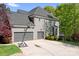 Spacious three-car garage with a large driveway and basketball hoop at 3934 Blue Dory Ln, Denver, NC 28037