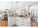 Well-lit open kitchen with granite island, stainless steel refrigerator, and adjacent dining area at 3934 Blue Dory Ln, Denver, NC 28037