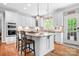 Modern kitchen features an island with granite countertops, stainless steel appliances and breakfast bar seating at 3934 Blue Dory Ln, Denver, NC 28037