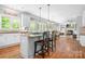 Spacious open kitchen with granite island flowing into a living room with fireplace at 3934 Blue Dory Ln, Denver, NC 28037