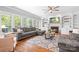 Cozy living room with large windows, fireplace, and built-in shelving for ample storage at 3934 Blue Dory Ln, Denver, NC 28037