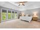 Bright, spacious bedroom with tray ceilings and large windows offering great natural light at 3934 Blue Dory Ln, Denver, NC 28037