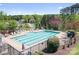Aerial view of a large community pool surrounded by lounge chairs and lush landscaping at 3934 Blue Dory Ln, Denver, NC 28037