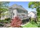 Exterior view of home with large deck, complemented by a well-manicured backyard and lush trees at 3934 Blue Dory Ln, Denver, NC 28037