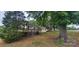 Quaint yellow house featuring a covered porch and mature trees in a serene neighborhood setting at 403 Branch St, Kings Mountain, NC 28086