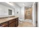Bathroom features granite countertop, a walk-in shower with glass door, and a spacious vanity at 4213 Stockbrook Dr, Charlotte, NC 28215