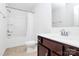 Bathroom featuring a shower-tub combo and a wooden vanity with modern fixtures at 4213 Stockbrook Dr, Charlotte, NC 28215