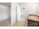 Bathroom featuring walk-in closet and vanity with granite countertop at 4213 Stockbrook Dr, Charlotte, NC 28215
