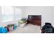 Bare bedroom with a bed frame by the window offers bright, natural light at 4213 Stockbrook Dr, Charlotte, NC 28215