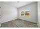 A bedroom with hardwood floors and natural light coming in through the window at 4213 Stockbrook Dr, Charlotte, NC 28215