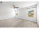 Bright bedroom features neutral-toned carpet, a ceiling fan, and ample natural light at 4213 Stockbrook Dr, Charlotte, NC 28215