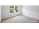 This cozy bedroom features neutral-toned carpet and ample natural light at 4213 Stockbrook Dr, Charlotte, NC 28215