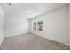 This bright bedroom features neutral-toned carpet and ample natural light at 4213 Stockbrook Dr, Charlotte, NC 28215