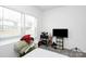Bright bedroom with a large window, comfortable bed, and entertainment setup for relaxation at 4213 Stockbrook Dr, Charlotte, NC 28215