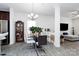Open dining area with modern chandelier, wood floors, and direct access to the kitchen at 4213 Stockbrook Dr, Charlotte, NC 28215