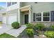 Close up view of the entrance, featuring manicured landscaping, and neutral siding at 4213 Stockbrook Dr, Charlotte, NC 28215
