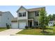Charming two-story home featuring a two-car garage, neutral siding, and well-maintained landscaping at 4213 Stockbrook Dr, Charlotte, NC 28215