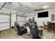 Spacious garage with ample storage, a seating area, and an entertainment setup, perfect for hobbies and gatherings at 4213 Stockbrook Dr, Charlotte, NC 28215