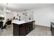Open-concept kitchen flows into the dining and living area, offering an island with a sink and stainless dishwasher at 4213 Stockbrook Dr, Charlotte, NC 28215