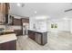 Modern kitchen featuring dark wood cabinets, stainless steel appliances, a stylish backsplash, and marble countertops at 4213 Stockbrook Dr, Charlotte, NC 28215